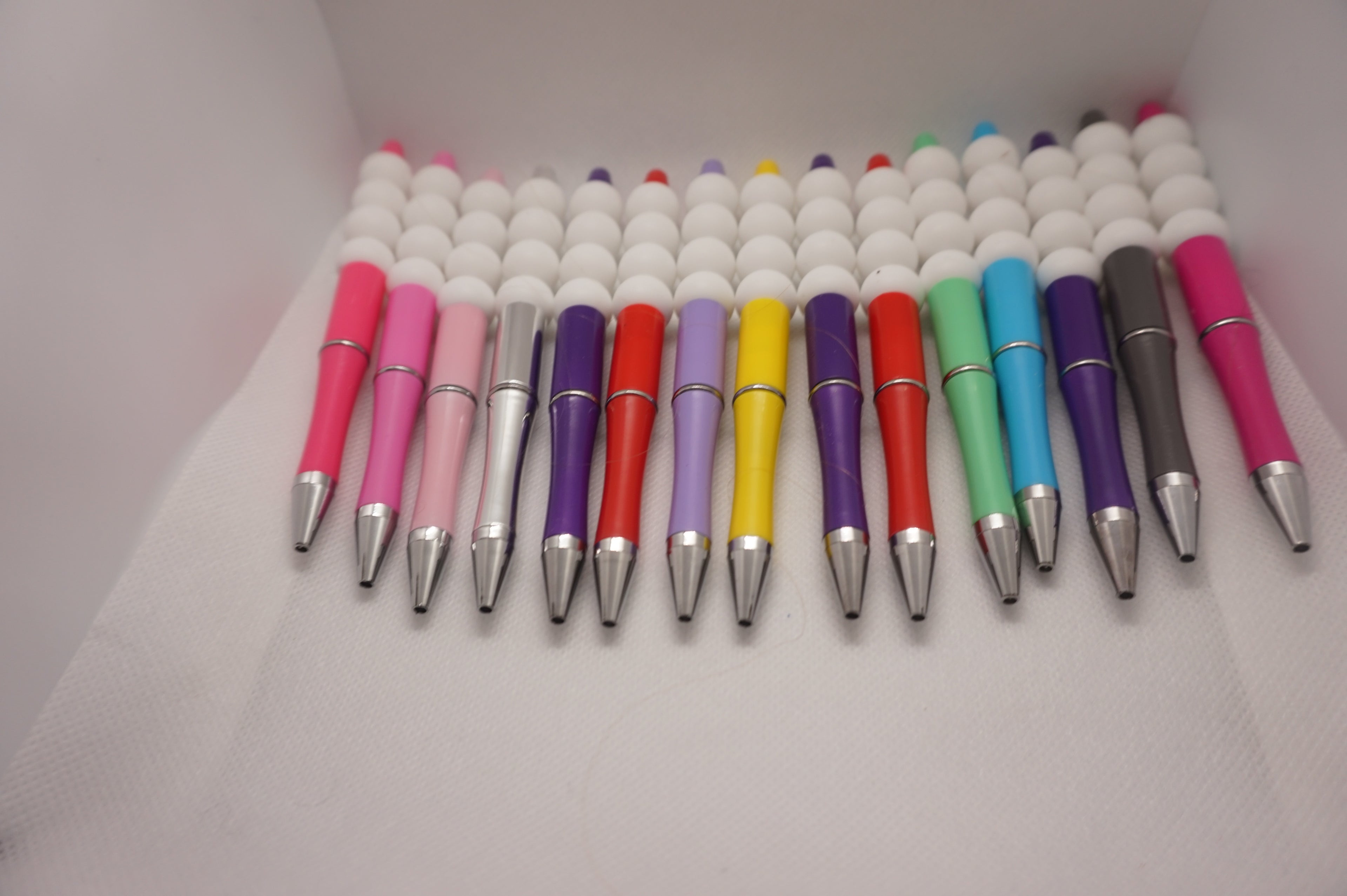 Handcrafted beaded pens with colorful, decorative beads.